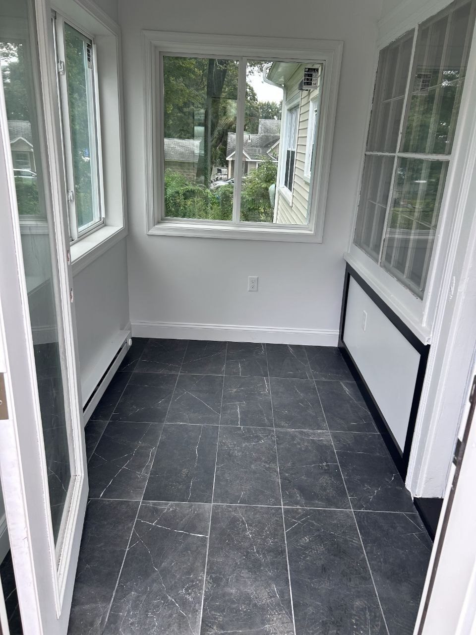 Inside the finished addition: tile floor, new windows and trim