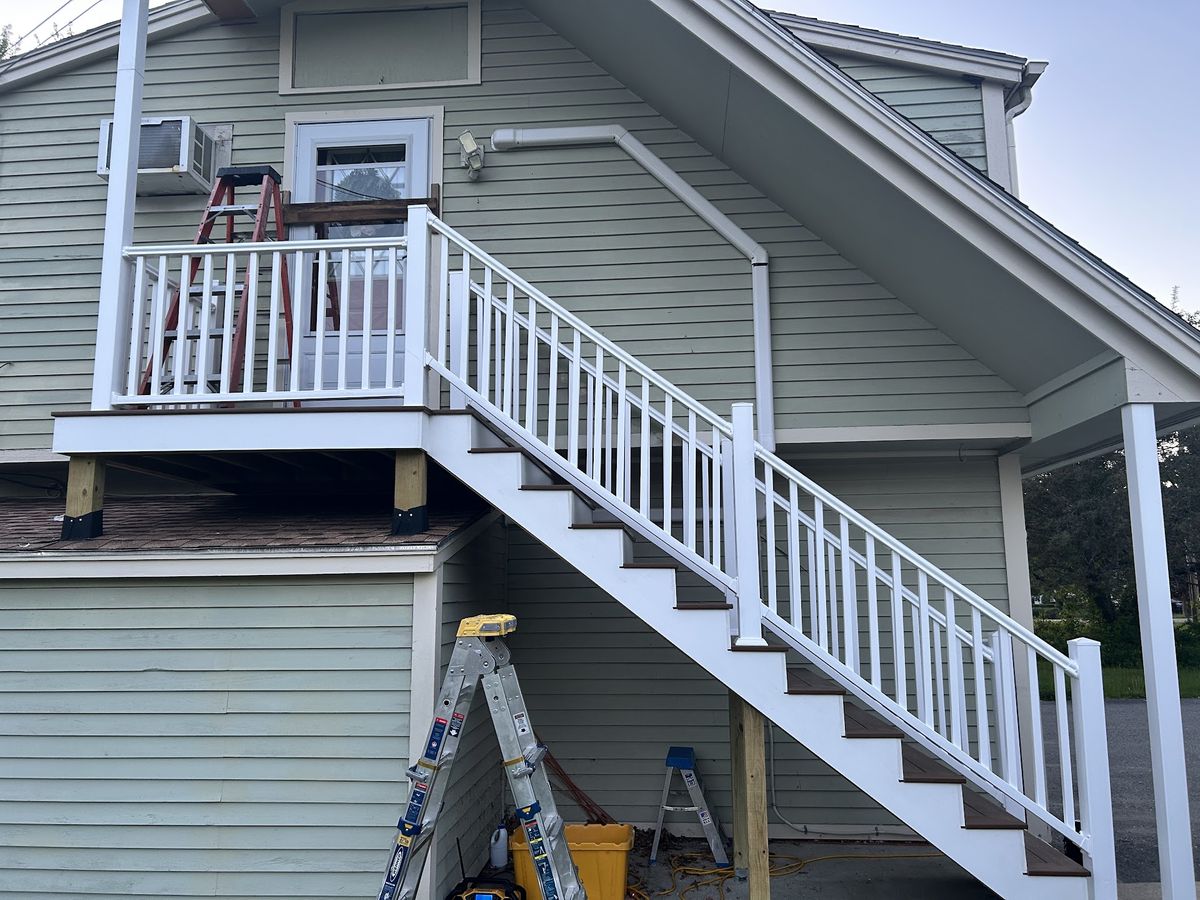 New exterior deck stairs with white railings
