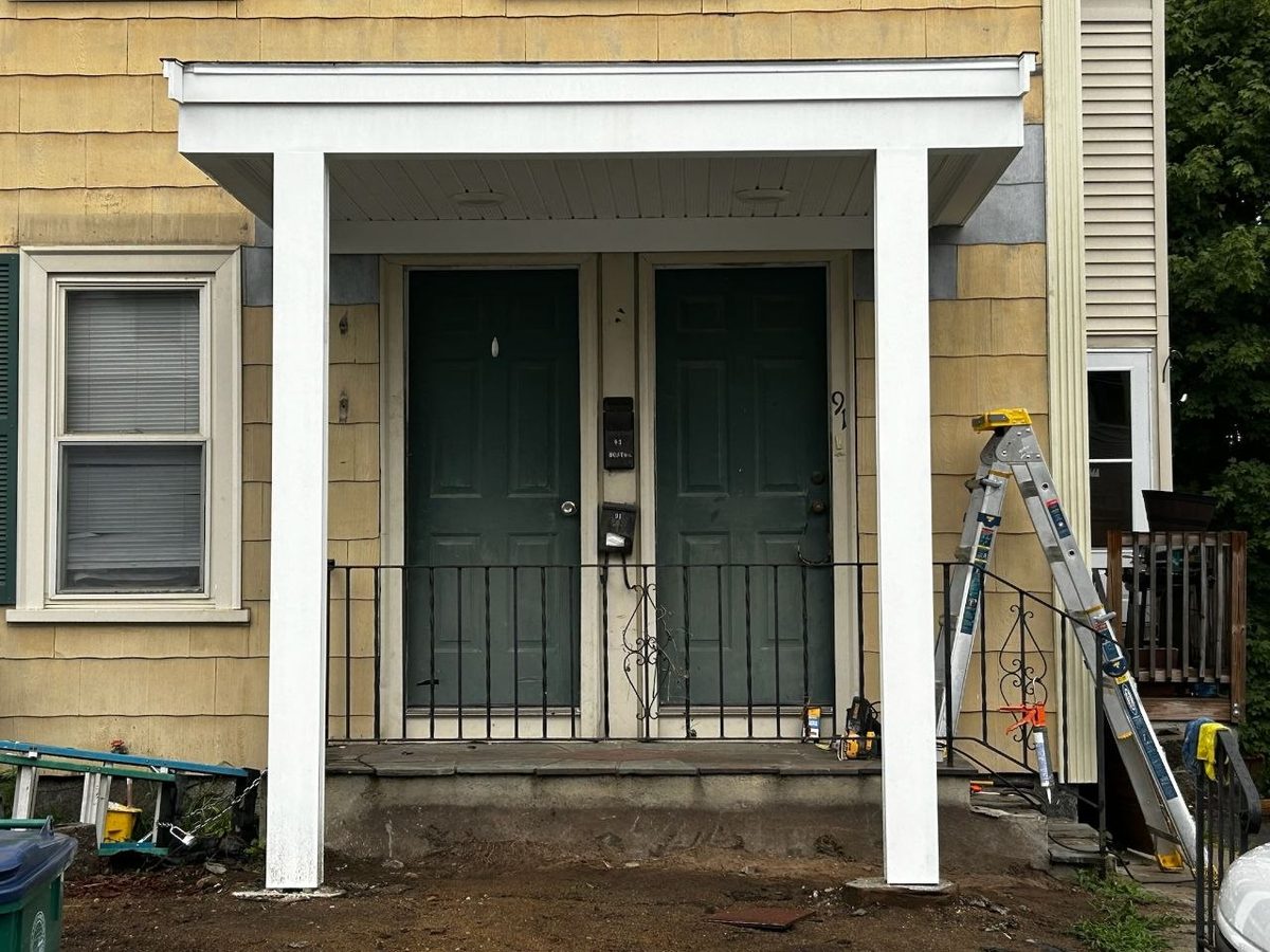 After: finished front portico with wrapped columns, trimmed fascia and beadboard ceiling by Genesis Building Services