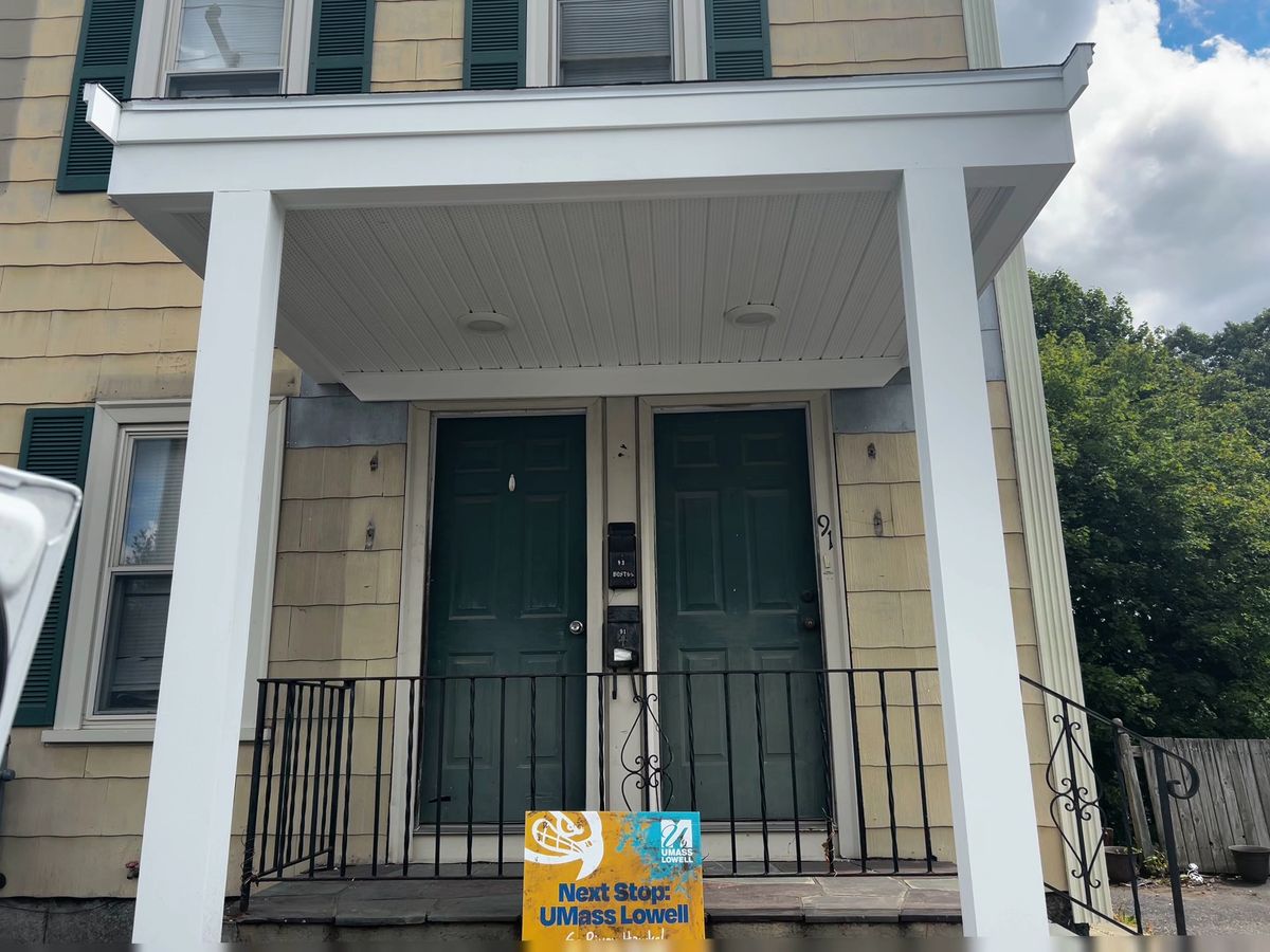 Finished front porch with wrapped columns built by Genesis Building Services